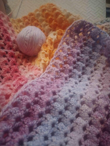 An up close of the rainbow baby blanket while being made